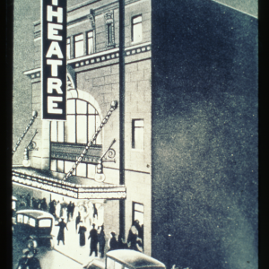 A photograph showing the outside of the Walk Theatre, with people and cars passing by. Source: City of Winnipeg Archives.
