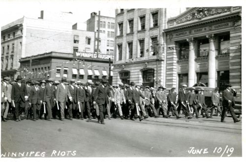 Special Police marching west down Portage from Main Street, June 10 Riot.  Winnipeg Tribune Photograph Collection. UMASC.